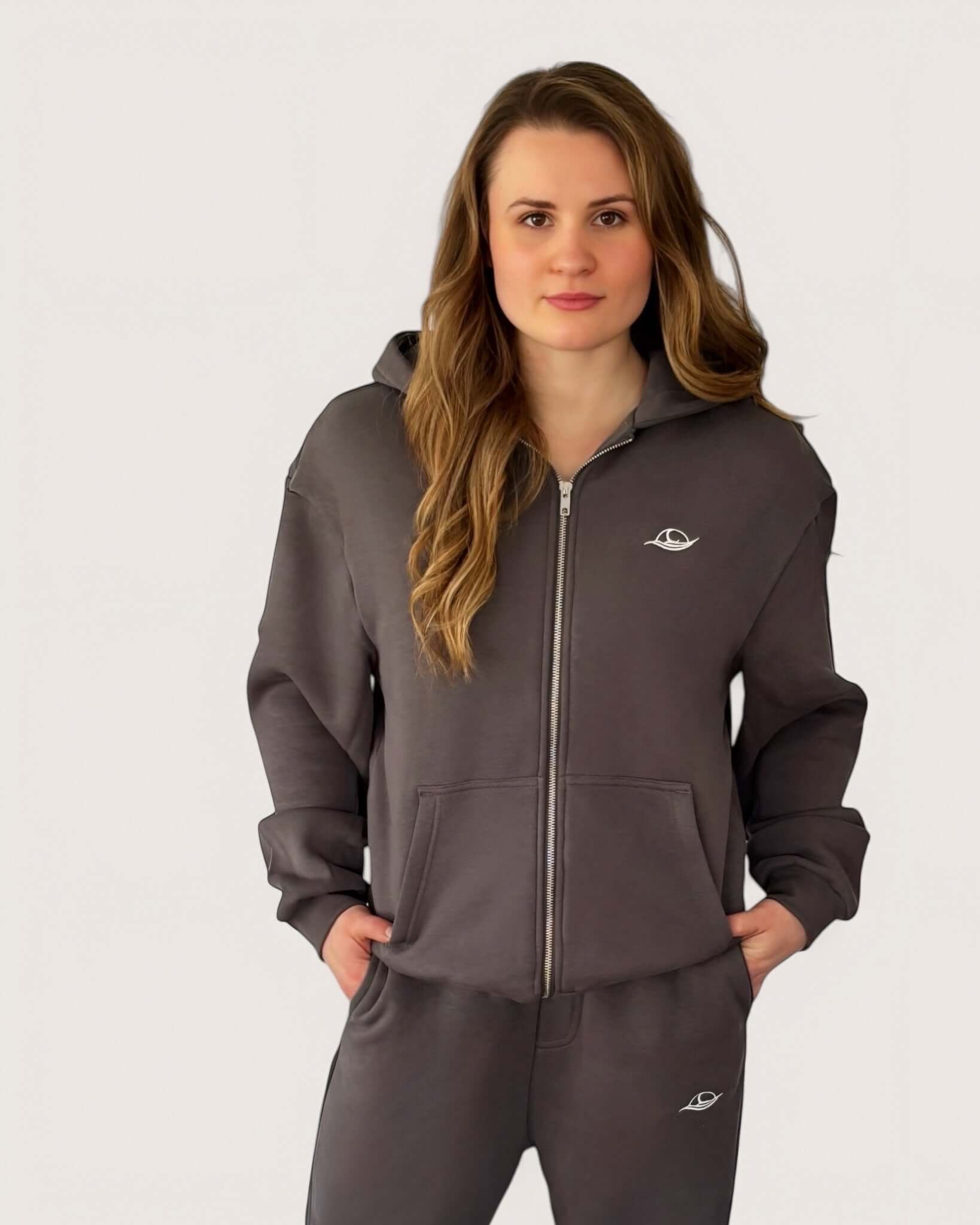 Heavy Essential Zip Hoodie | Graphite worn by a model, showcasing the oversized fit and embroidered logo.