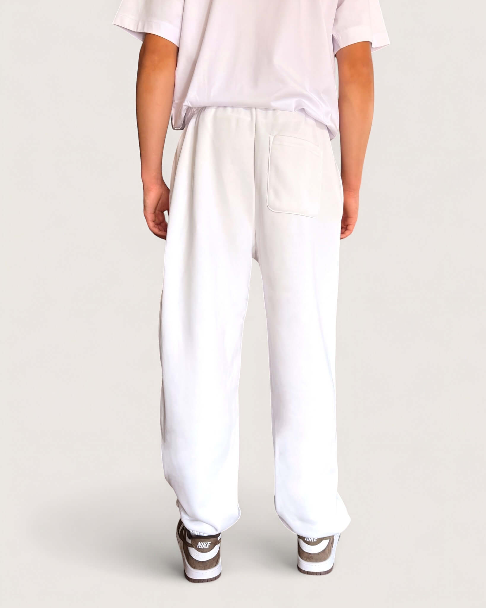 Heavy Essential Sweatpants | White, showing the back view with pockets in a loose fit style.