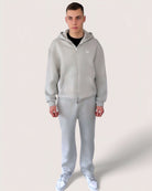 Heavy Essential Zip Hoodie | Light Grey worn by a model, showcasing an oversized fit in light grey color.