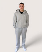 Heavy Essential Zip Hoodie | Light Grey model wearing oversized fit hoodie and matching pants in light grey.