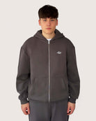 Heavy Essential Zip Hoodie | Graphite worn by a model, showcasing its oversized fit and stylish design.
