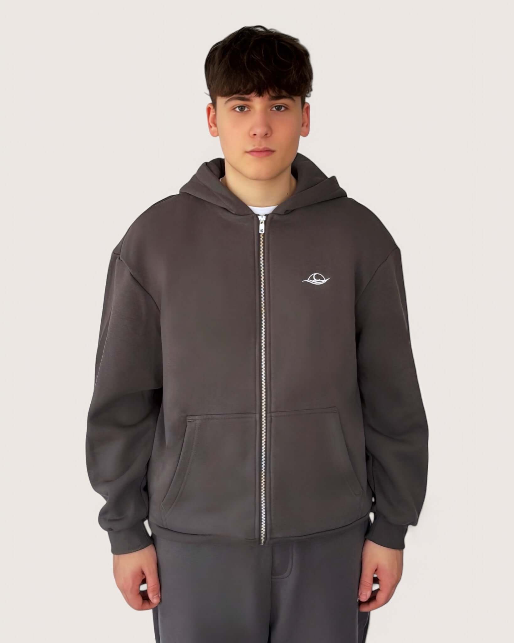 Heavy Essential Zip Hoodie | Graphite worn by a model, showcasing its oversized fit and stylish design.