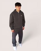 Heavy Essential Zip Hoodie | Graphite worn by a model, showcasing an oversized fit and comfortable fabric.